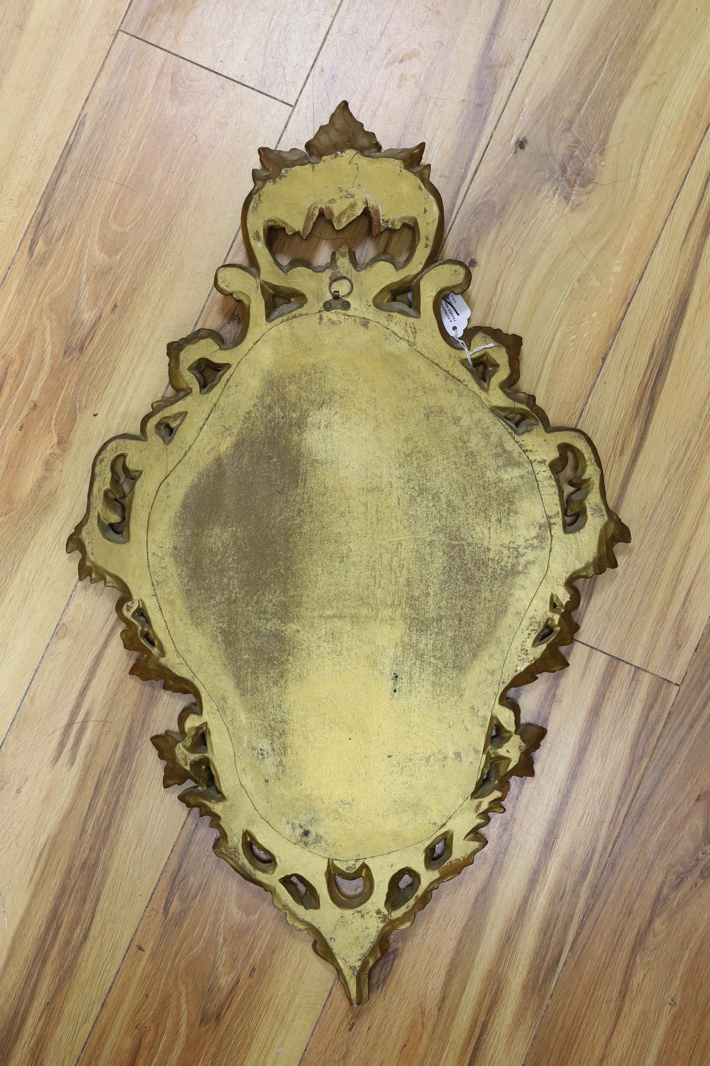 A reproduction gilt framed wall mirror, in the Rococo style, 73cm tall